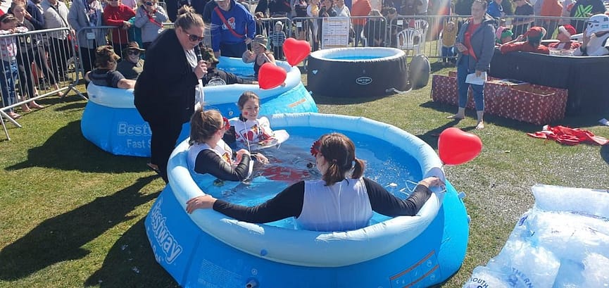 people sat in inflatable pool at fundraising event