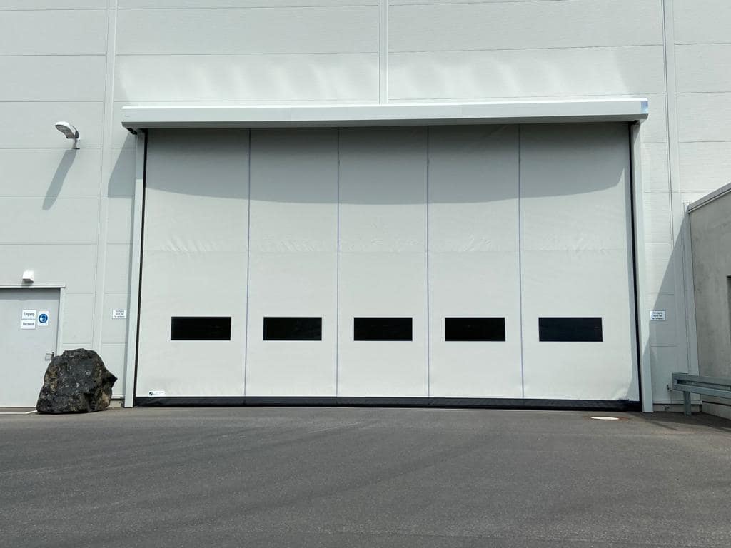 Large white Ulti EX5 Door installed on a warehouse exterior.