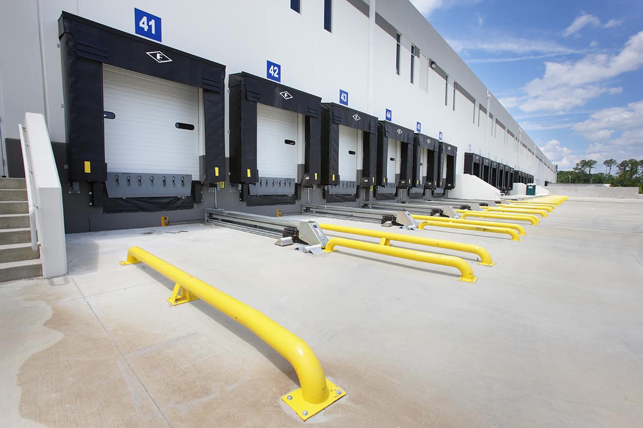 Loading dock bays with yellow wheel guides and black dock shelters.