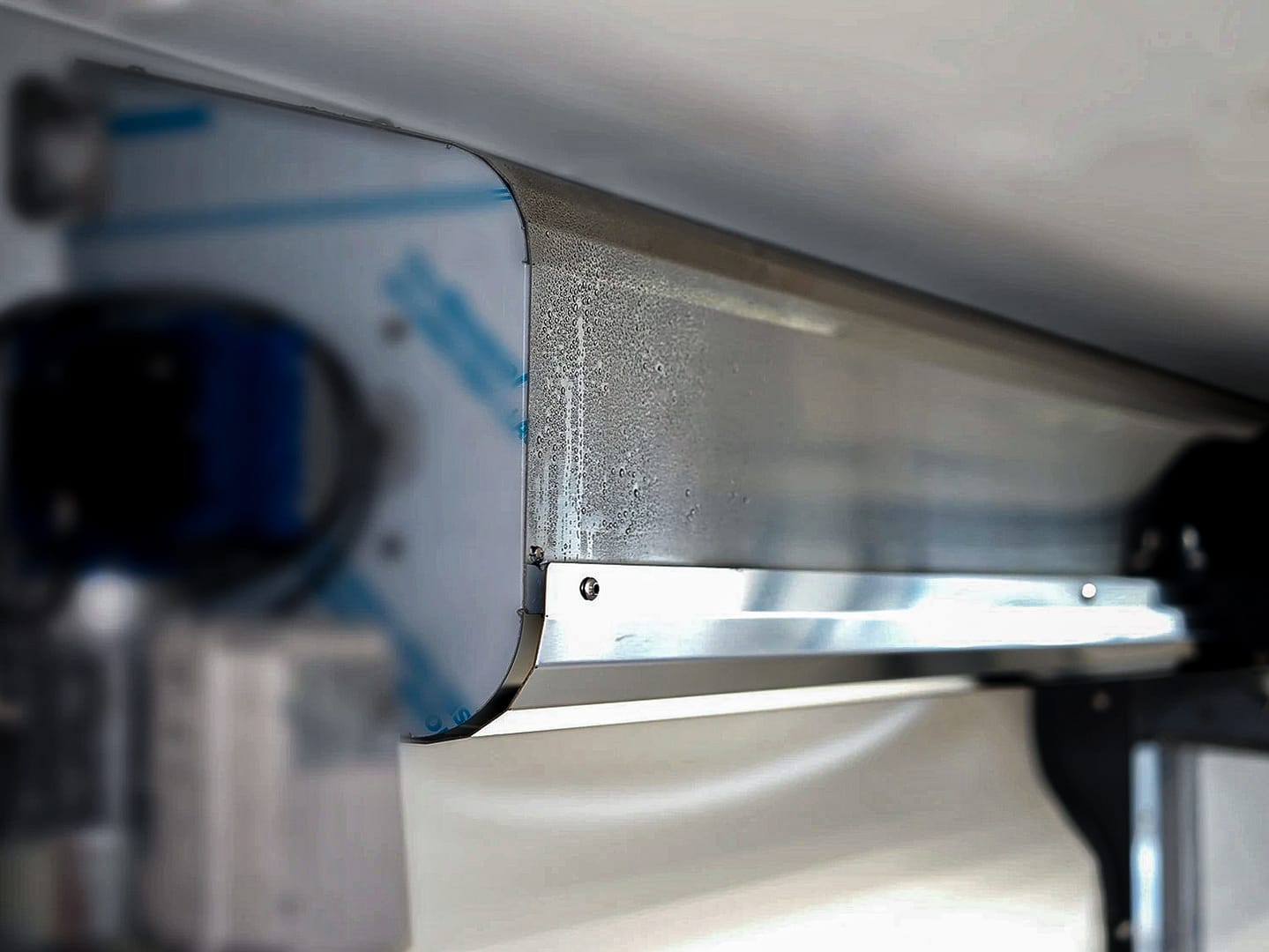 Stainless steel hood of an Ulti-Roll Clean door with condensation droplets.