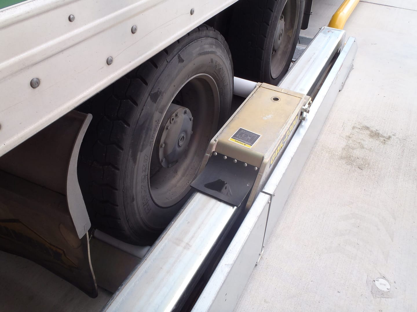 Global Wheel Lock vehicle restraint engaged against a truck tyre at a loading dock.