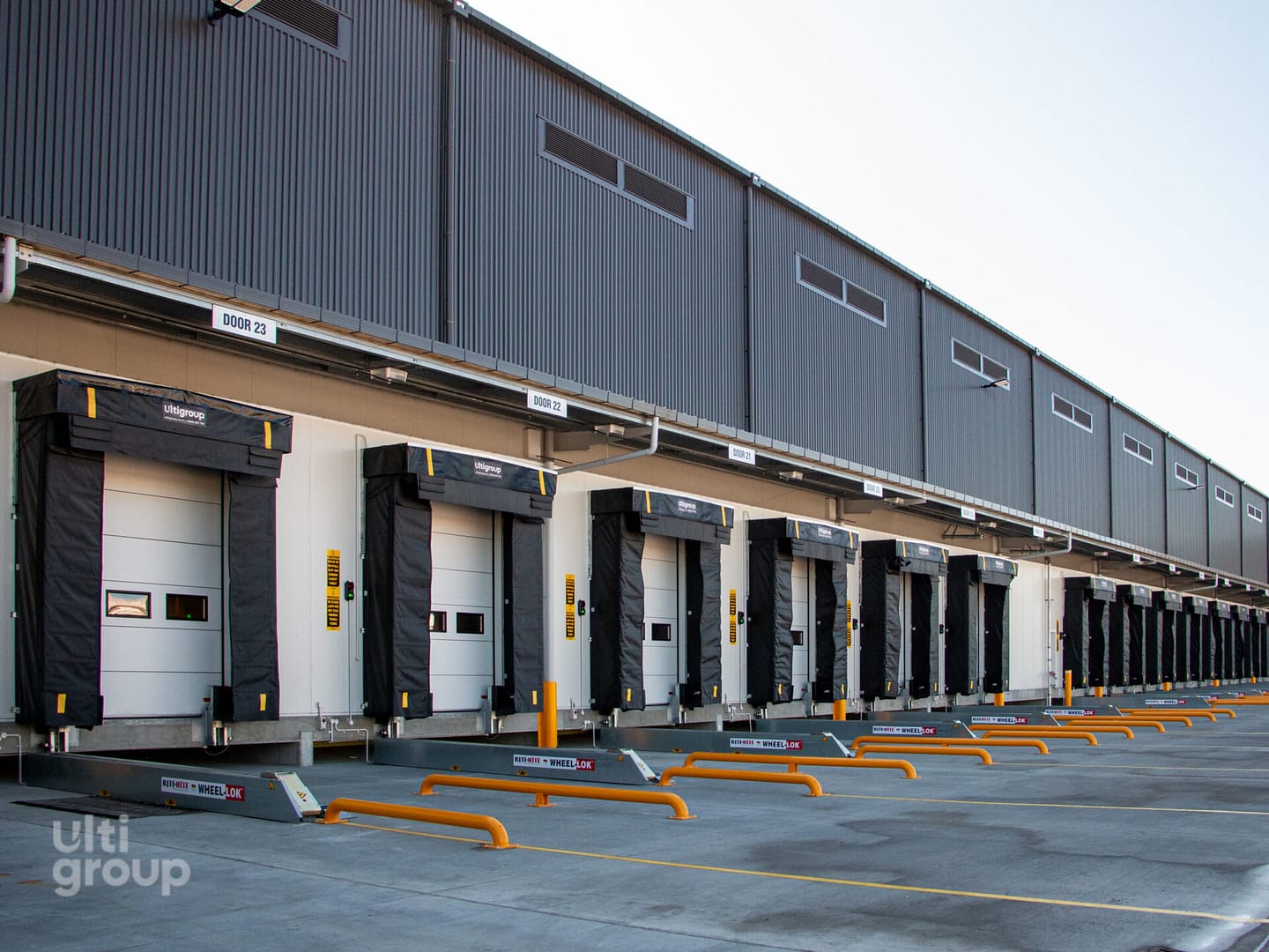 Row of loading docks with Rite-Hite Wheel-Lok vehicle restraints.