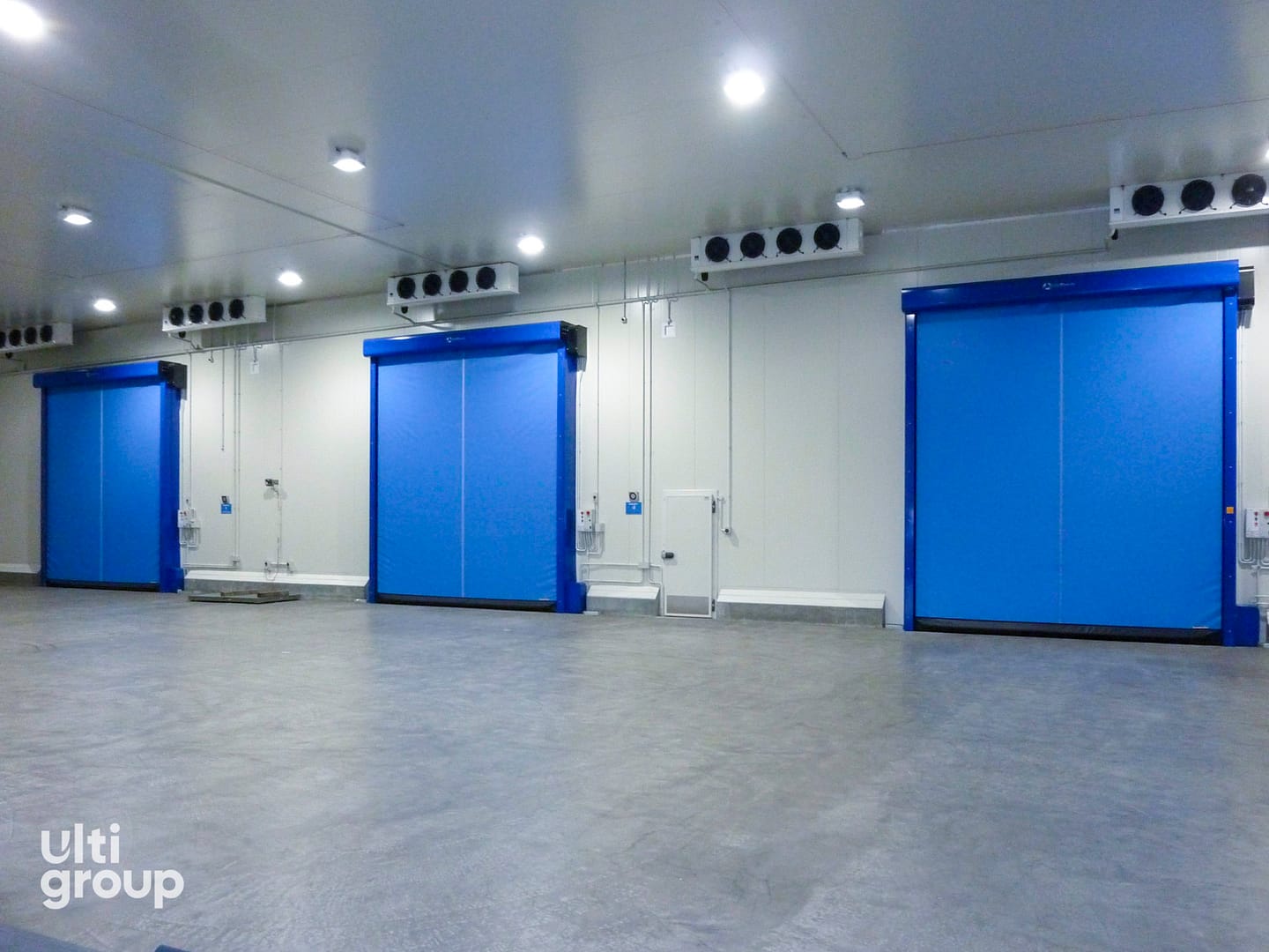 Three blue Ulti DuoTherm insulated high speed doors in a cold storage facility.