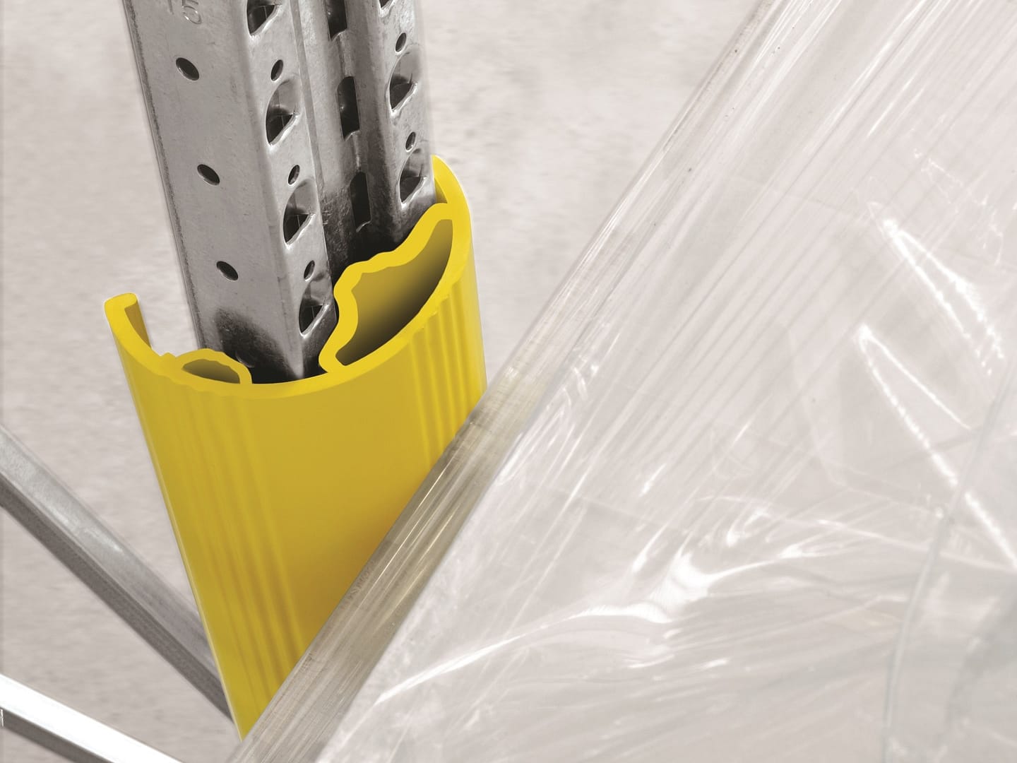 Yellow plastic rack protector installed on a metal warehouse upright.