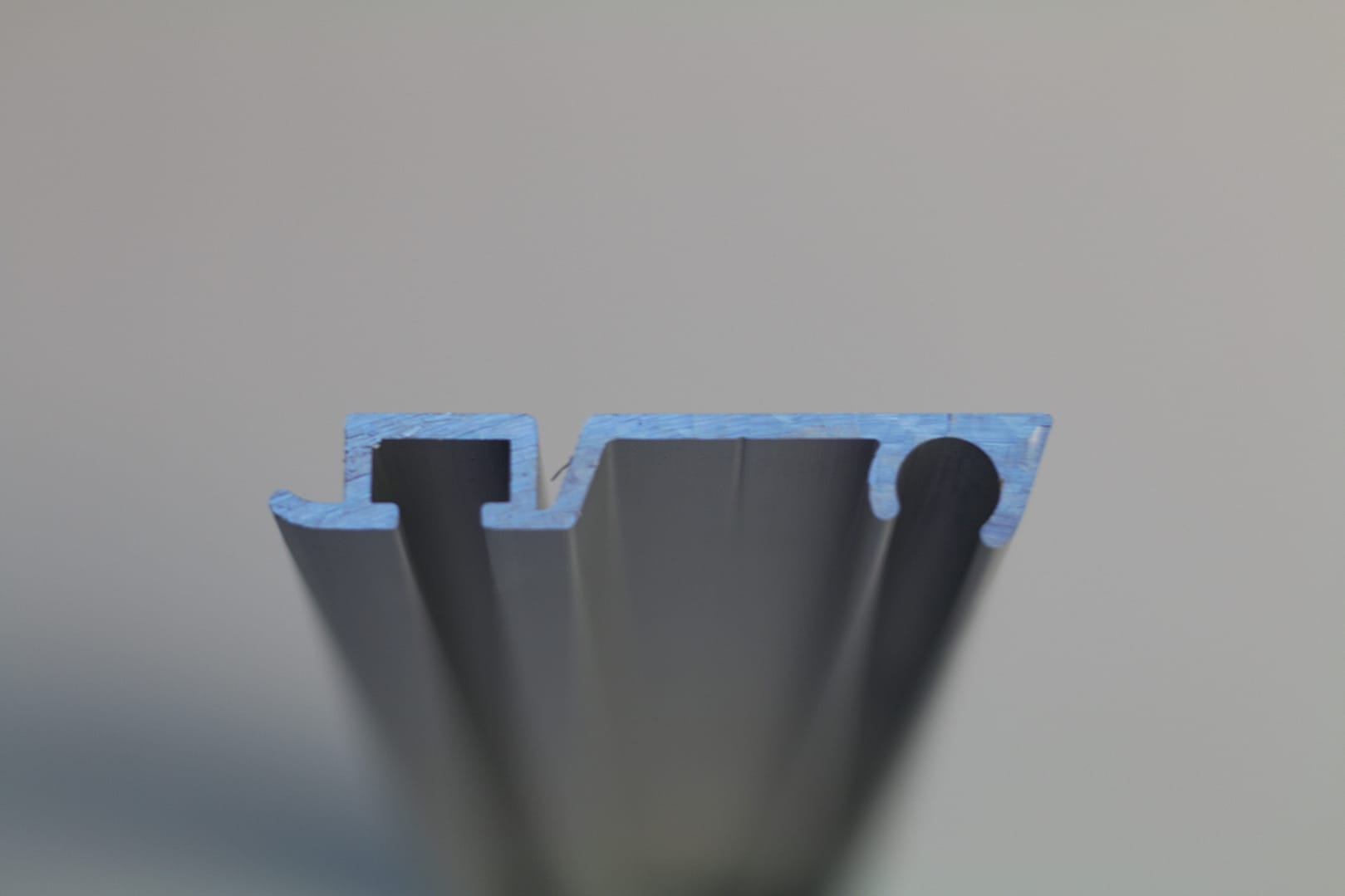 Cross-section profile of a grey aluminium door extrusion.