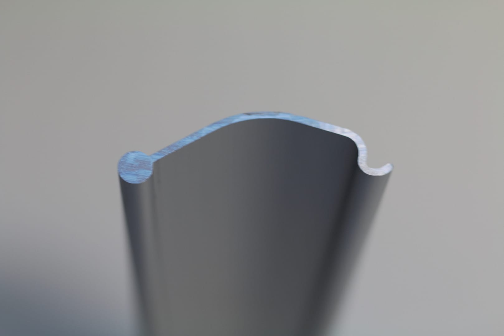 Cross-section profile of a grey aluminium door extrusion.