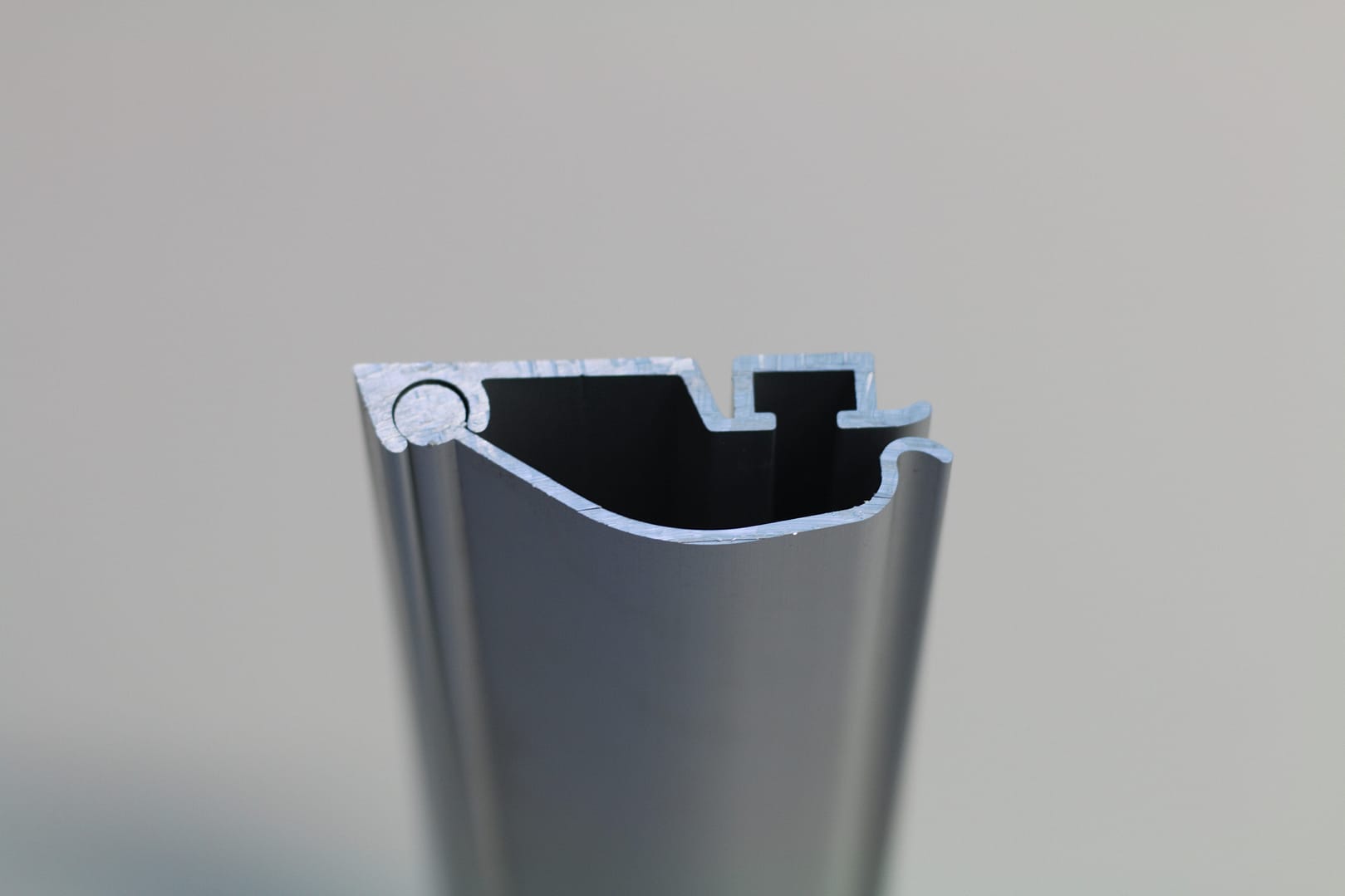 Cross-section profile of a grey aluminium door extrusion.