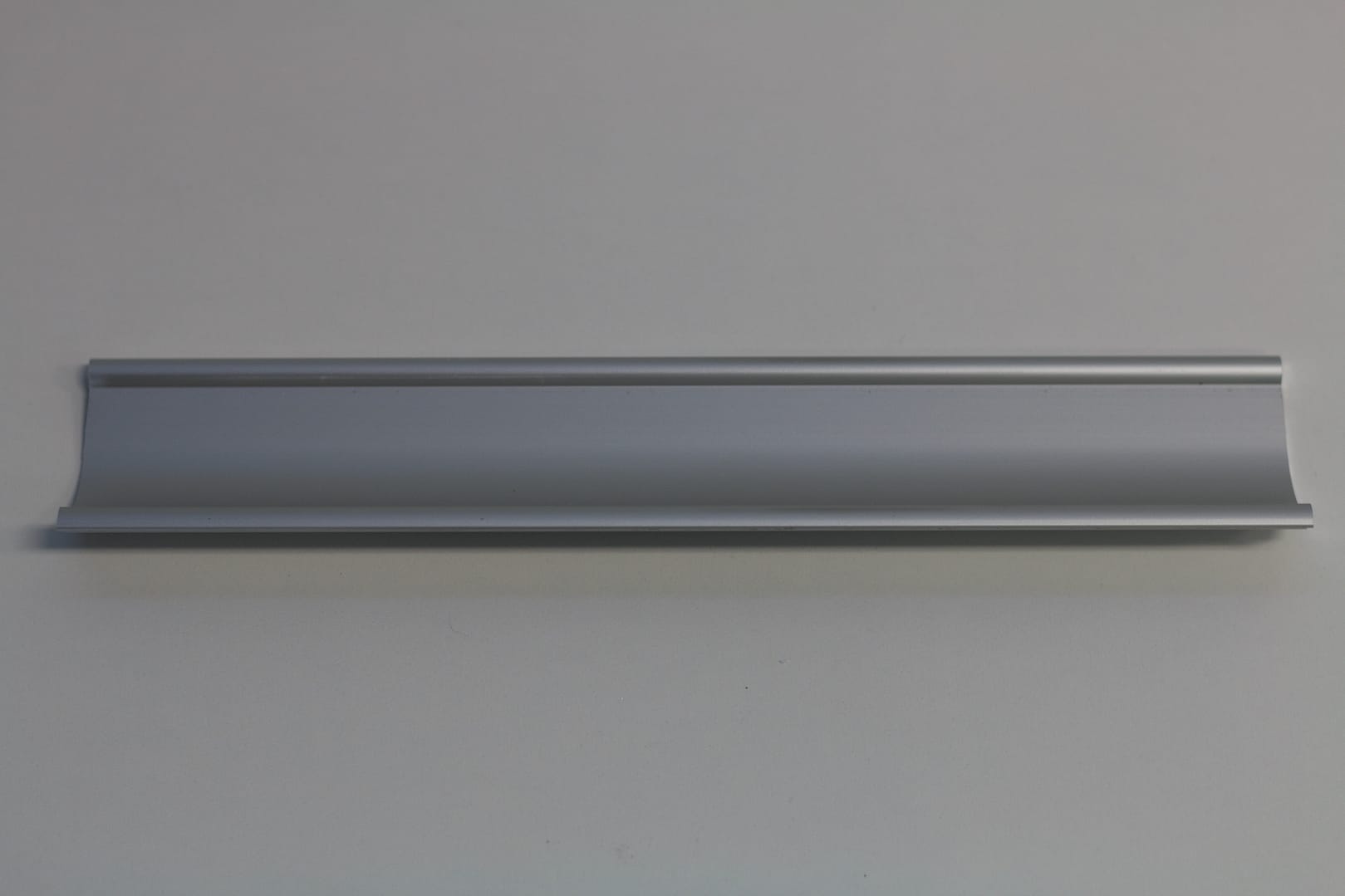 Silver anodised aluminium door handle profile.