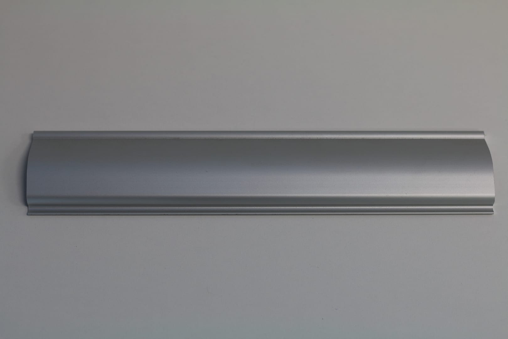 Silver anodised aluminium profile for industrial door components.