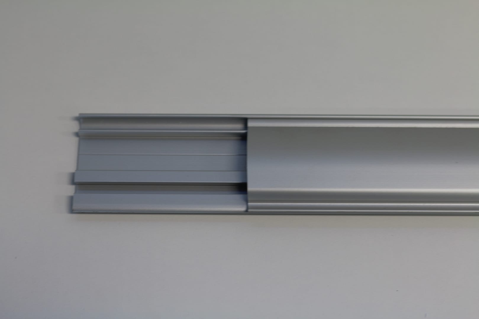 Close-up of a silver anodised aluminium door track profile.