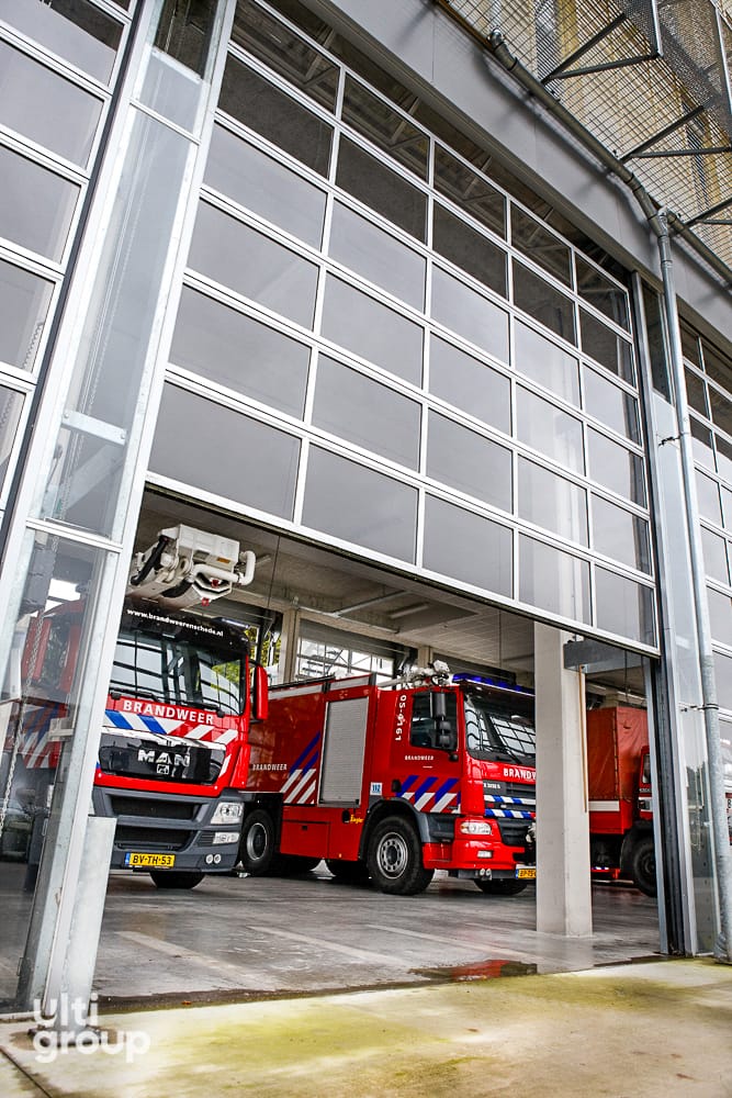 Full vision sectional door opening for fire trucks at a station.