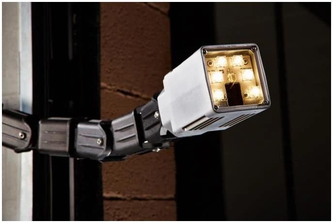 FlexNeck LED loading dock light illuminating a warehouse interior.
