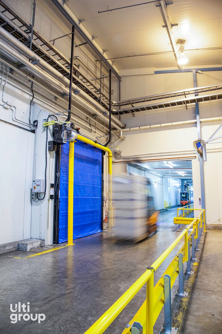 A blue Fastrax FR Door installed in a cold storage facility.