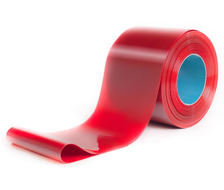 A roll of red translucent PVC strip material for industrial strip curtains.