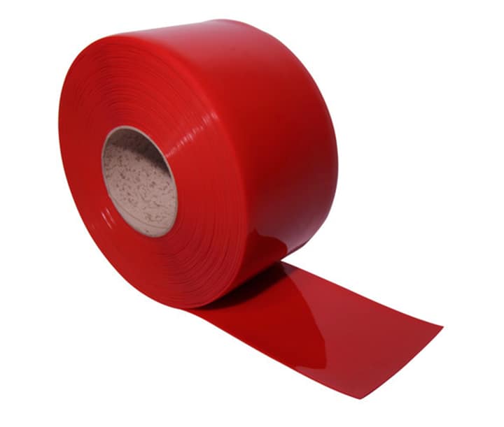 Roll of red translucent PVC strip for industrial welding screens.