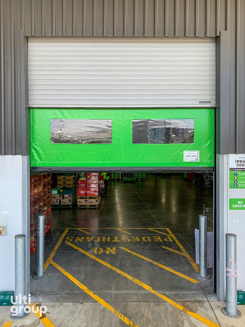 Ulti Komby Door installed at a warehouse entrance with safety floor markings.