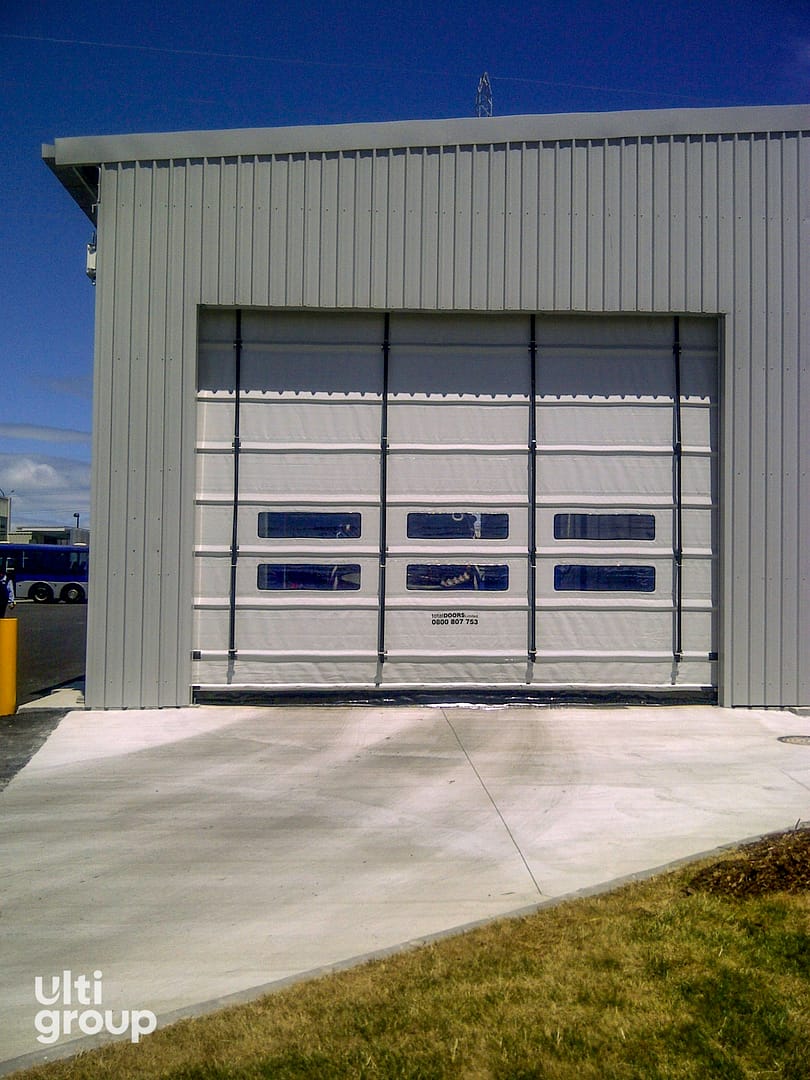 Ulti Fold rapid door installed on a grey corrugated metal building.