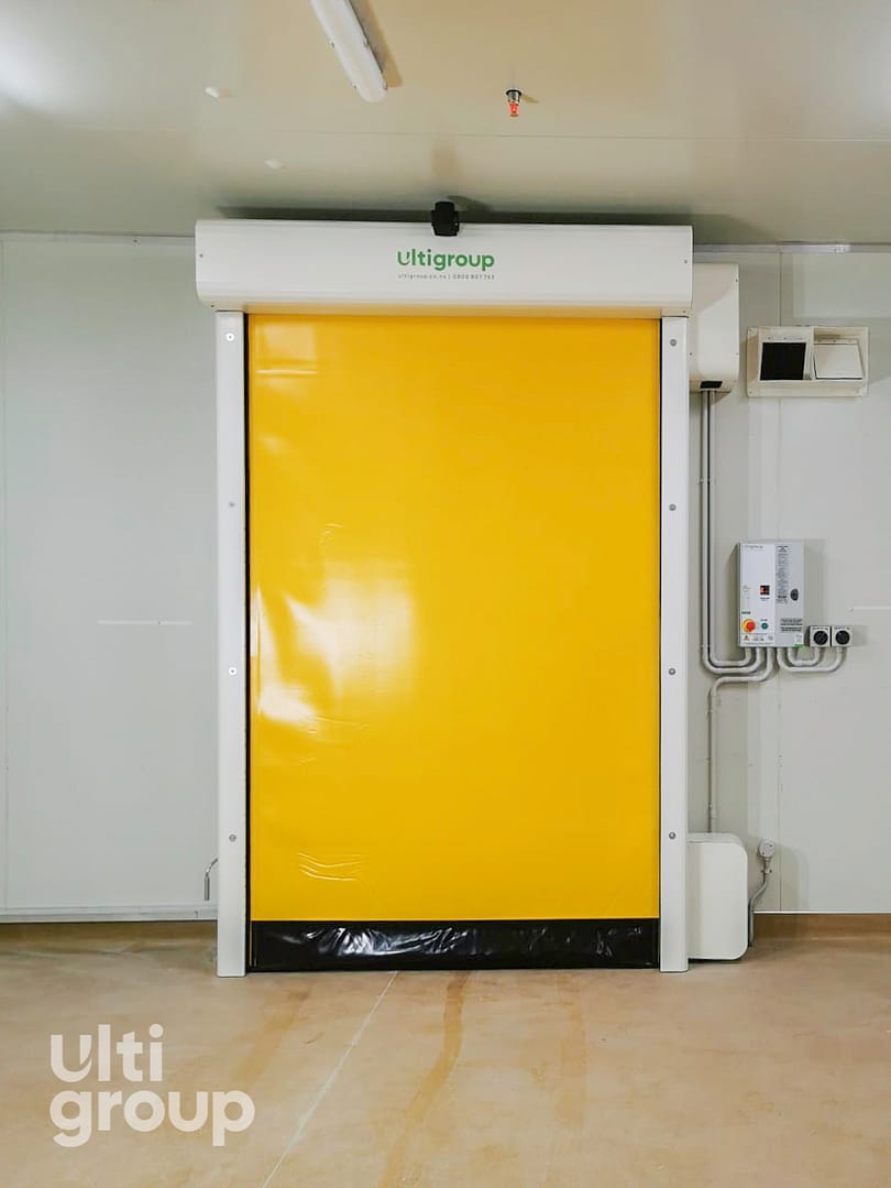 Yellow Ulti Group high speed freezer door installed in a cold storage facility.