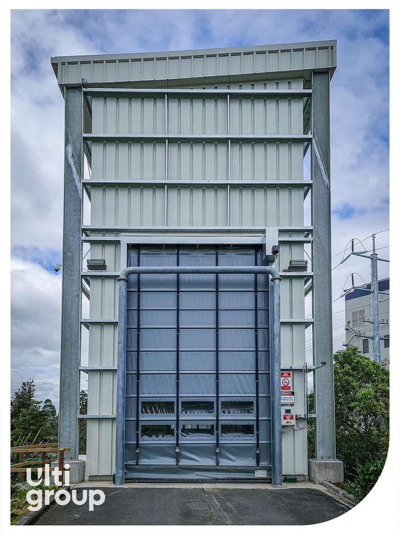Ulti Fold Door installed on a tall industrial enclosure.