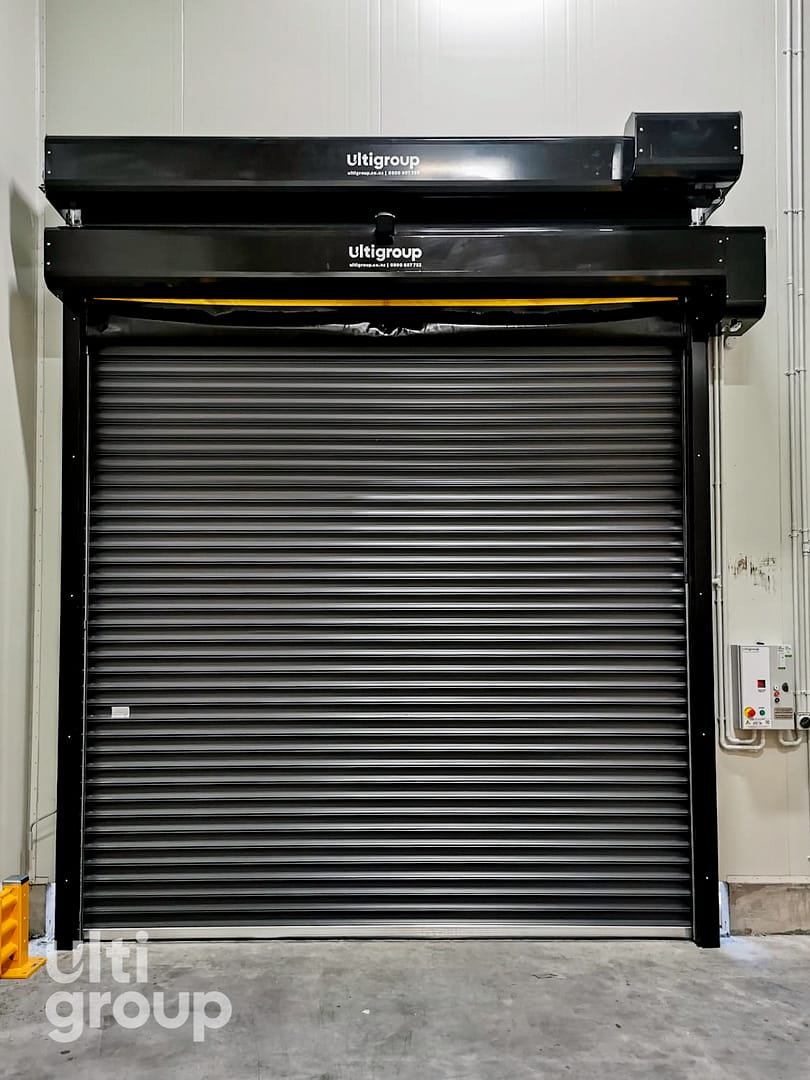 Black Ulti Komby Door installed in a warehouse facility.