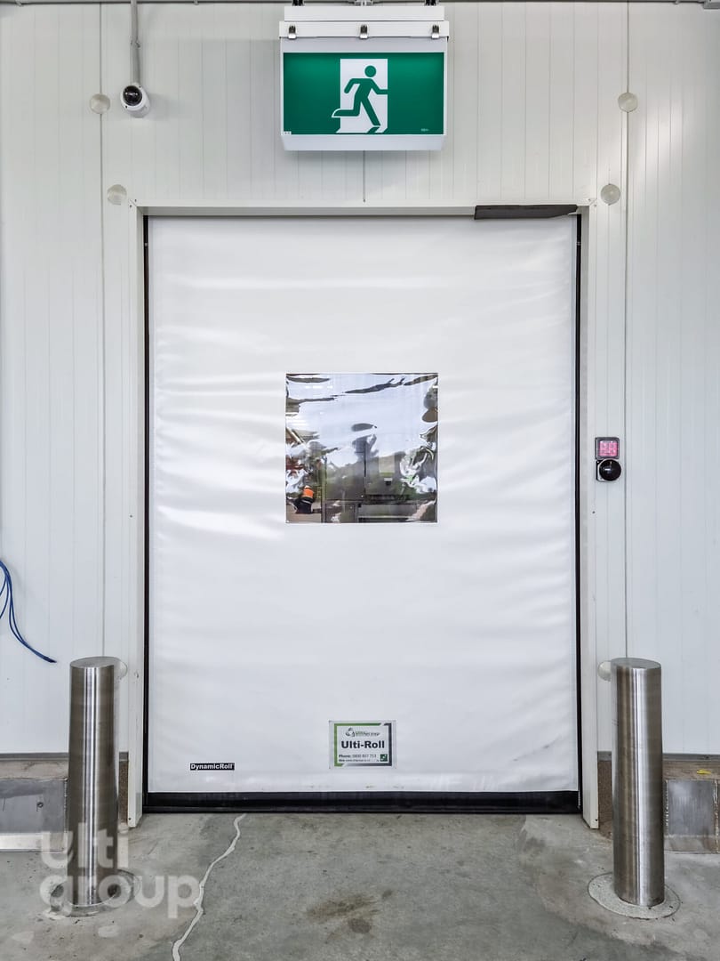 Ulti-Roll high speed door with vision panel and bollards