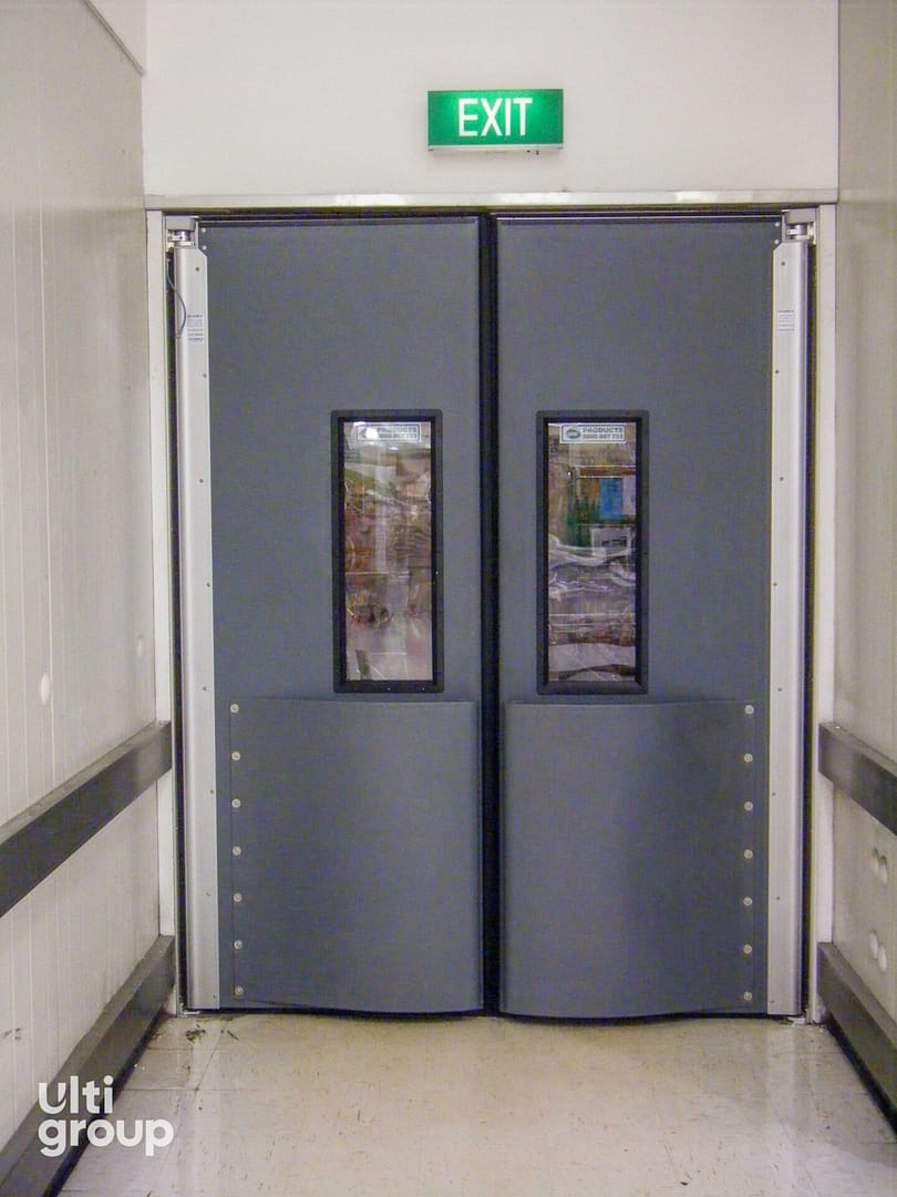 Ulti 4500 Series impact traffic doors installed in a supermarket corridor for hygiene control.