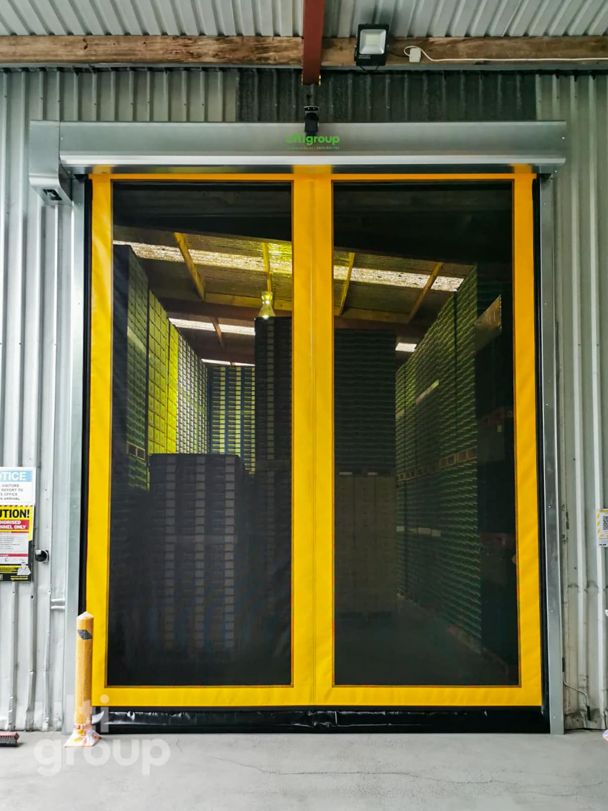 Yellow Ulti Roll Airflow door installed at a fruit packing facility.