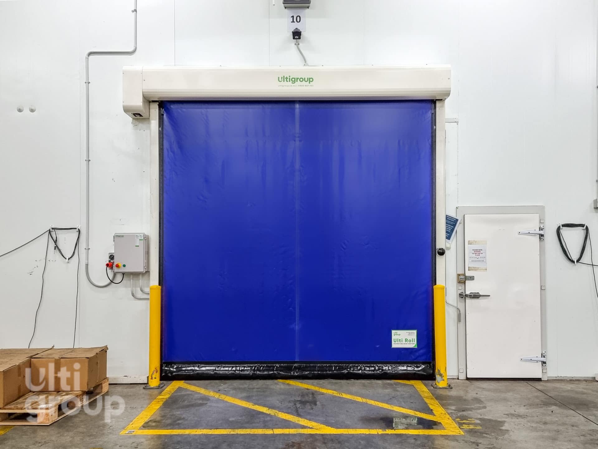 Blue Ulti Roll high speed door installed in a warehouse facility.
