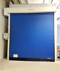 Blue Ulti Roll rapid door installed in a warehouse facility.