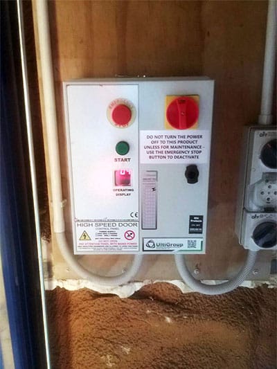 Control panel for a high speed door with emergency stop and start buttons.