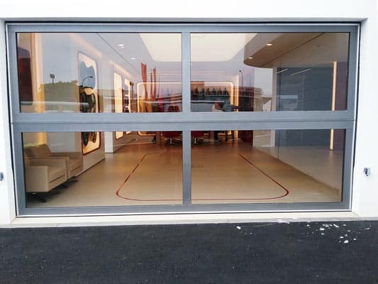 Full vision sectional door installed at a vehicle showroom entrance.