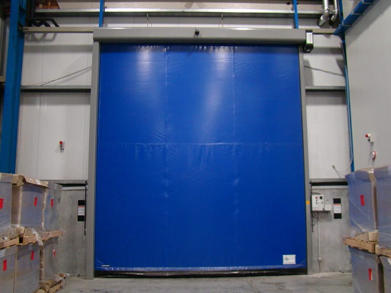 Blue Ulti-Roll insulated high speed door installed in a warehouse.