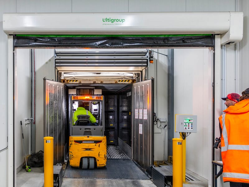 Forklift entering a truck through an Ulti Group dock loading system.