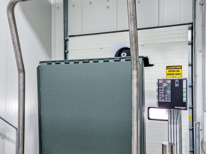 Vertical Storing Dock Leveller in upright position at a loading bay.
