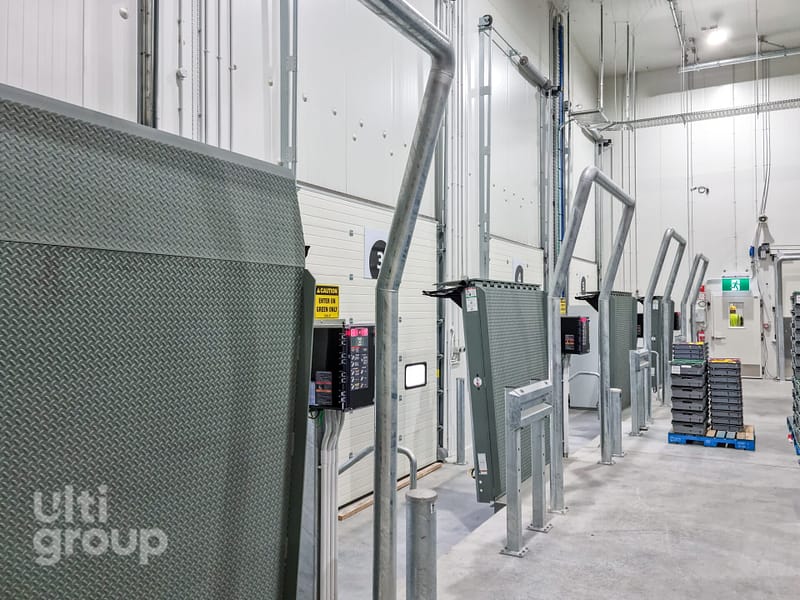 Row of Vertical Storing Dock Levellers in a loading bay facility.