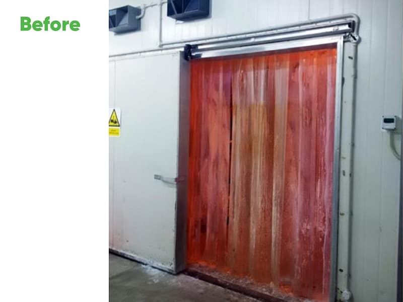 Red PVC strip curtain installed in a cold storage doorway.