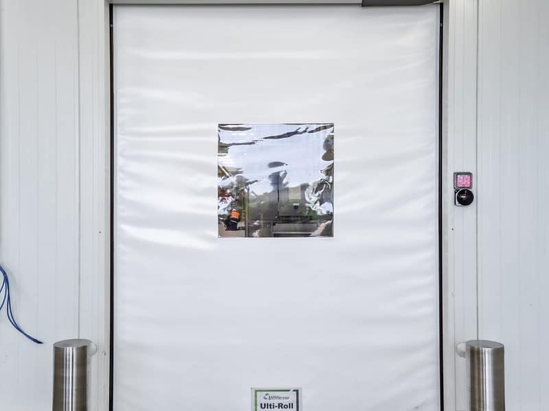 Ulti-Roll high speed door with vision panel and bollards
