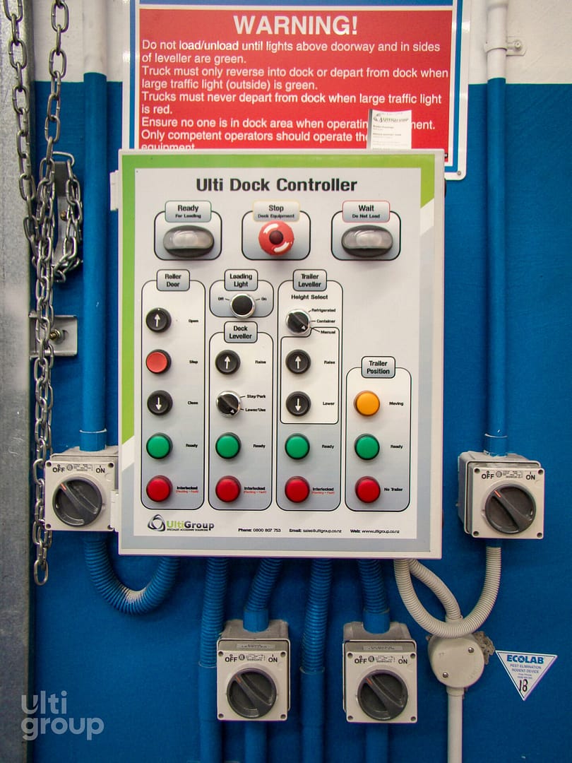 Ulti Dock Controller panel with push buttons and switches on a blue wall.