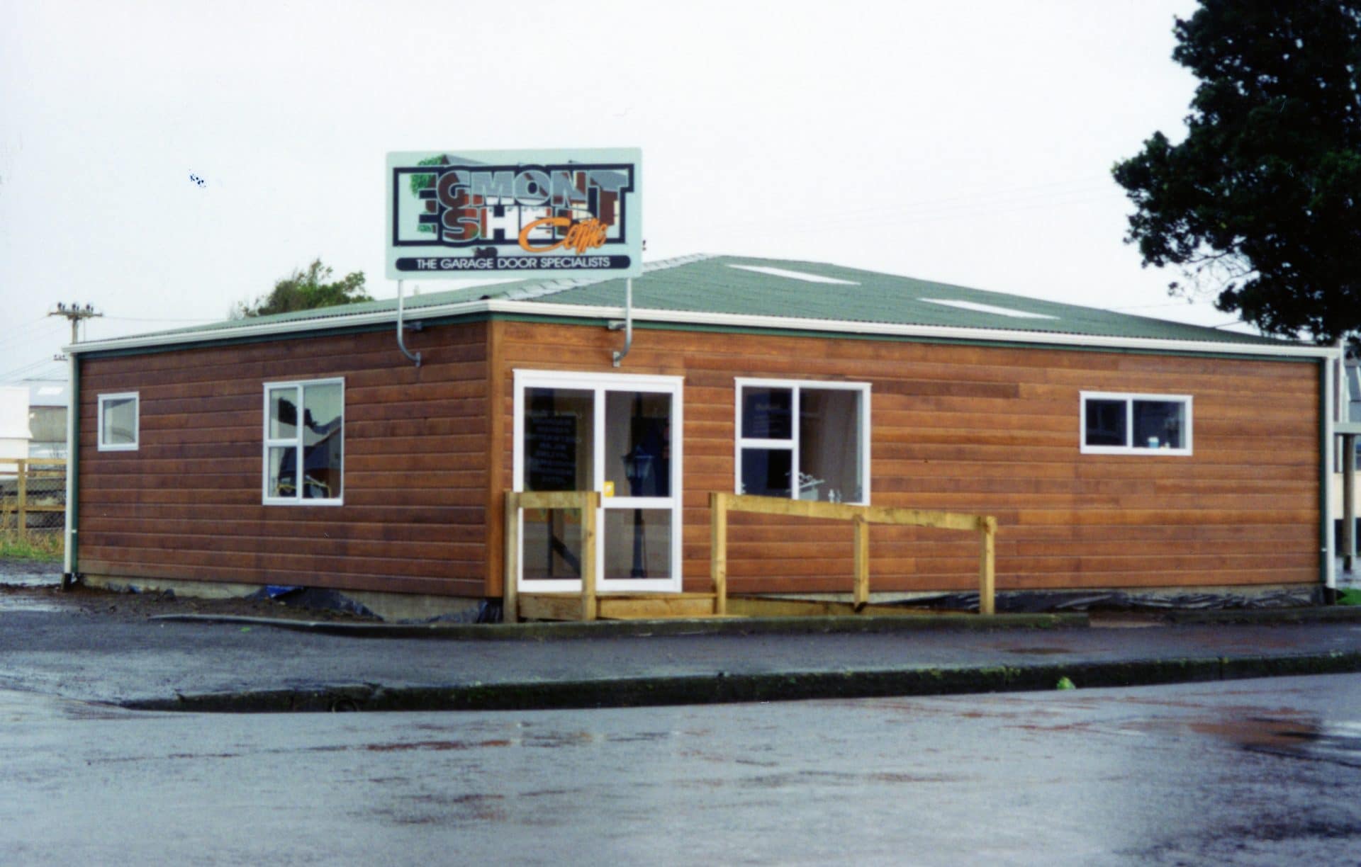 Small timber-clad building with Egmont Shed Centre signage.